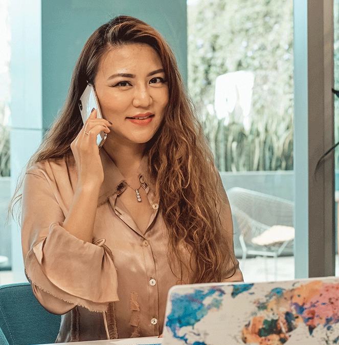 asian pacific islander woman on cell phone in office space